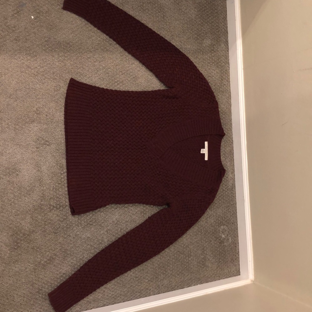 A maroon knitted v cut sweater